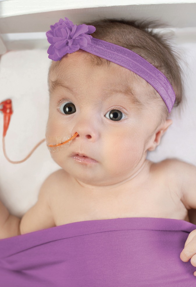 Baby with headband and blanket