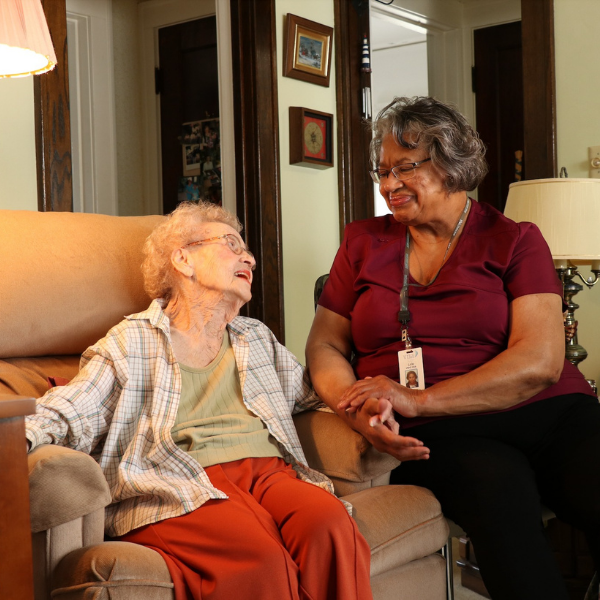 elderly lady sitting next to VNA home health aide